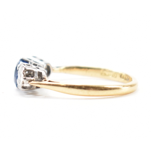 201 - An 18ct gold sapphire and diamond three stone ring. The ring being set with a round cut blue sapphir... 