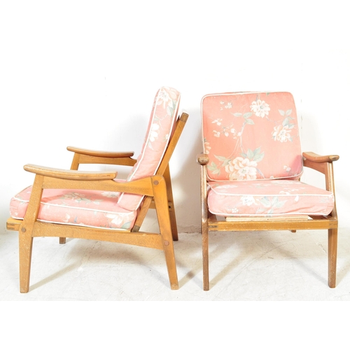 1151A - A pair of mid 20th Century pair of wooden teak framed armchairs being of Danish influence. The chair... 