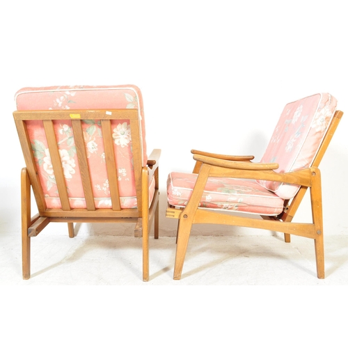 1151A - A pair of mid 20th Century pair of wooden teak framed armchairs being of Danish influence. The chair... 