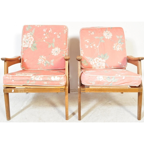 1151A - A pair of mid 20th Century pair of wooden teak framed armchairs being of Danish influence. The chair... 