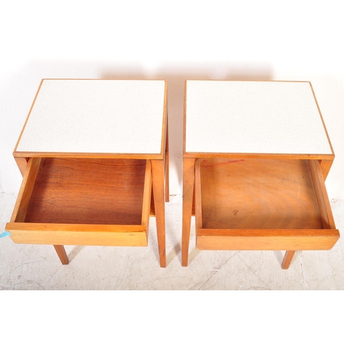 1161a - A pair of vintage mid 20th Century air ministry bedside tables. The tables having formica tops raise... 