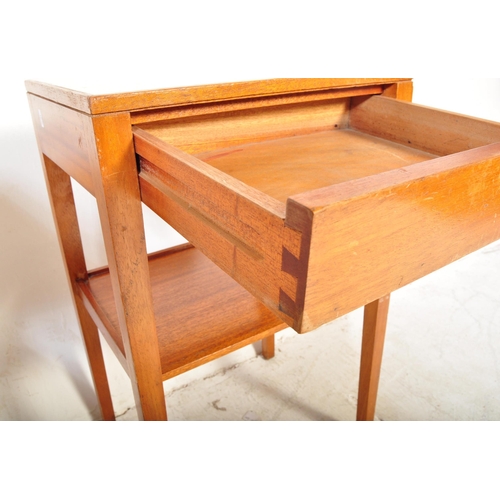 1161a - A pair of vintage mid 20th Century air ministry bedside tables. The tables having formica tops raise... 