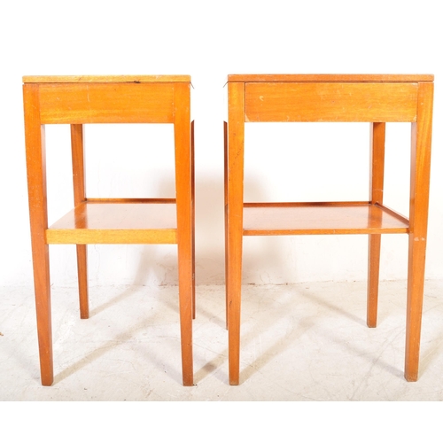 1161a - A pair of vintage mid 20th Century air ministry bedside tables. The tables having formica tops raise... 