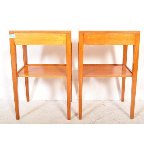 1161a - A pair of vintage mid 20th Century air ministry bedside tables. The tables having formica tops raise... 