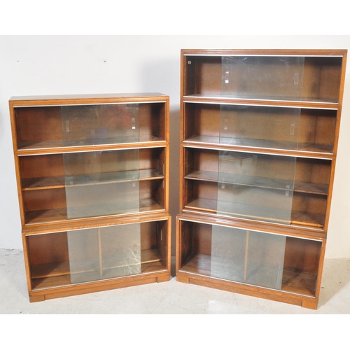 1163 - Two retro vintage mid 20th century Minty glazed teak cased bookcases having a series of glass slidin... 