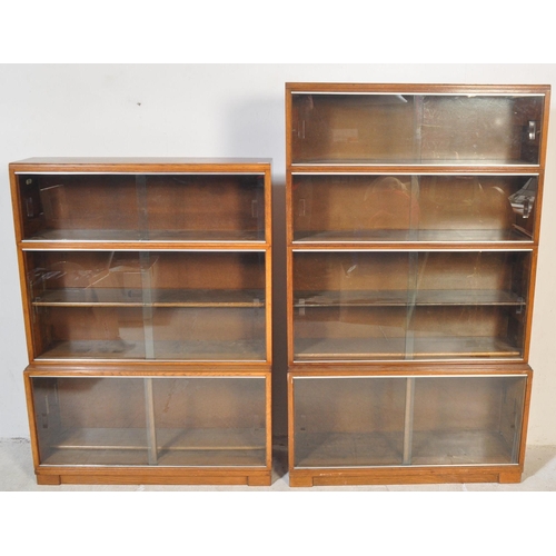 1163 - Two retro vintage mid 20th century Minty glazed teak cased bookcases having a series of glass slidin... 