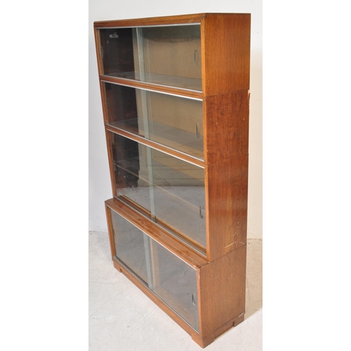 1163 - Two retro vintage mid 20th century Minty glazed teak cased bookcases having a series of glass slidin... 