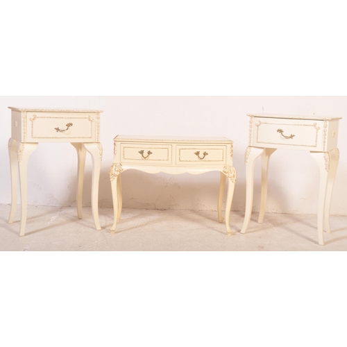 1164 - A pair of 20th century Louis XV style cream painted bedside tables. The pair of bedside cabinets hav... 