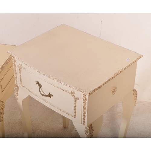 1164 - A pair of 20th century Louis XV style cream painted bedside tables. The pair of bedside cabinets hav... 