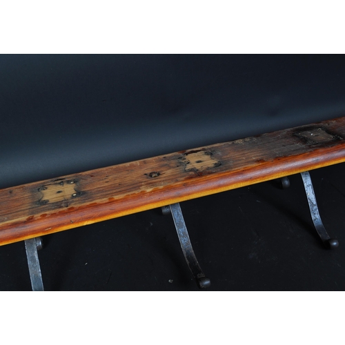 1165a - A 20th century coat rack rail having pine back board and a series of five white metal hooks.