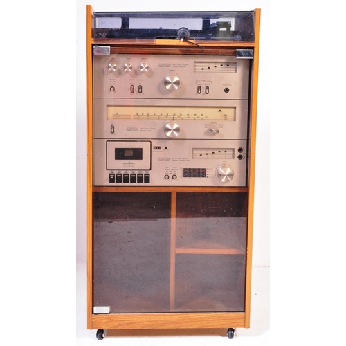 1166 - A retro 1970's hi-fi stereo system within glass and teak veneer case. Amstrad stereo system to inclu... 