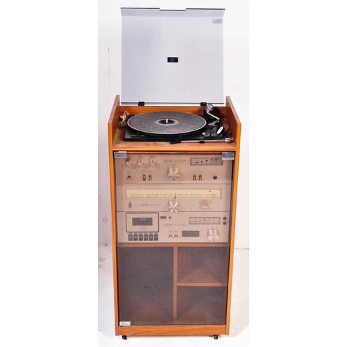 1166 - A retro 1970's hi-fi stereo system within glass and teak veneer case. Amstrad stereo system to inclu... 