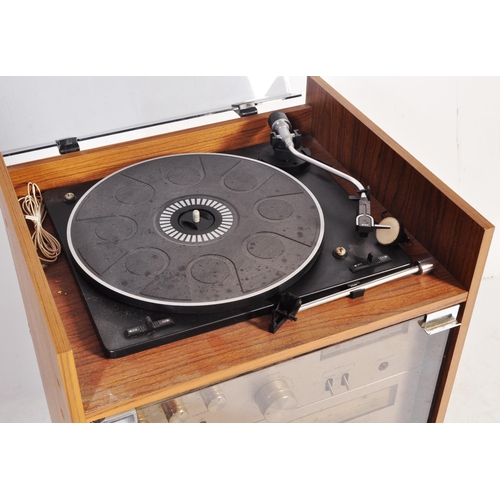 1166 - A retro 1970's hi-fi stereo system within glass and teak veneer case. Amstrad stereo system to inclu... 