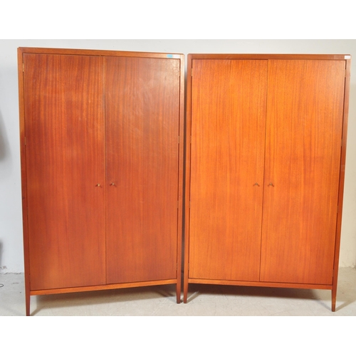 1174 - A 1960's mid century teak pair of wardrobes by Loughborough Furniture and retailed by Heals, London.... 