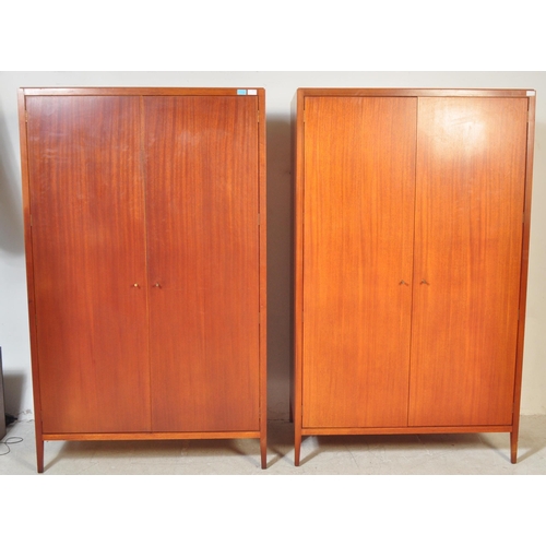 1174 - A 1960's mid century teak pair of wardrobes by Loughborough Furniture and retailed by Heals, London.... 