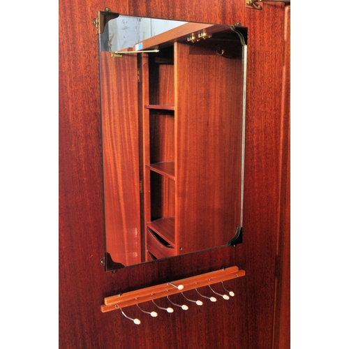 1174 - A 1960's mid century teak pair of wardrobes by Loughborough Furniture and retailed by Heals, London.... 