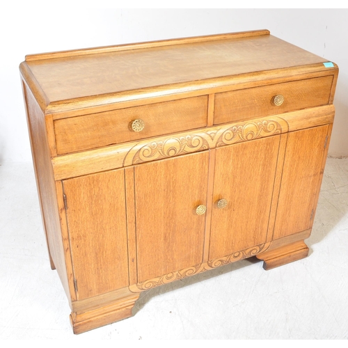 1175A - A 1930's Art Deco oak sideboard credenza. Raised on bracket shaped feet with twin door cupboard havi... 