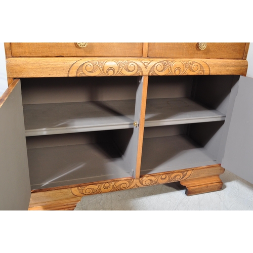 1175A - A 1930's Art Deco oak sideboard credenza. Raised on bracket shaped feet with twin door cupboard havi... 