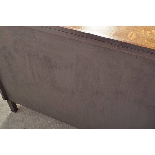 1175A - A 1930's Art Deco oak sideboard credenza. Raised on bracket shaped feet with twin door cupboard havi... 