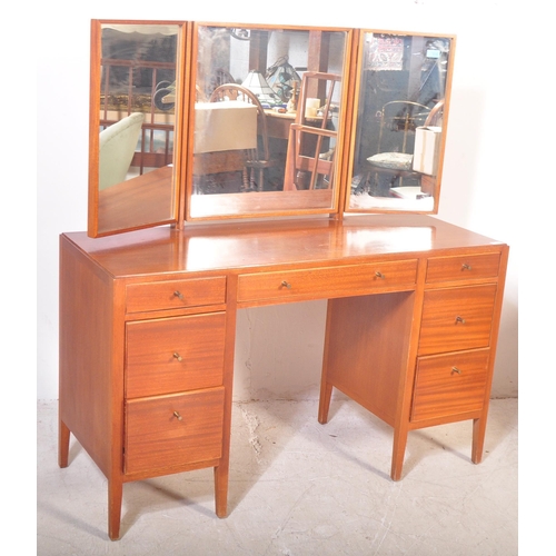 1175 - A 1960's mid century teak dressing table by Loughborough Furniture and retailed by Heals, London. Th... 