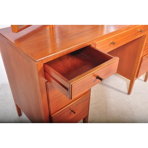 1175 - A 1960's mid century teak dressing table by Loughborough Furniture and retailed by Heals, London. Th... 