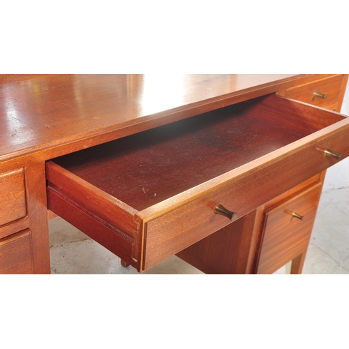 1175 - A 1960's mid century teak dressing table by Loughborough Furniture and retailed by Heals, London. Th... 