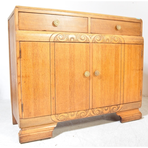 1175A - A 1930's Art Deco oak sideboard credenza. Raised on bracket shaped feet with twin door cupboard havi... 