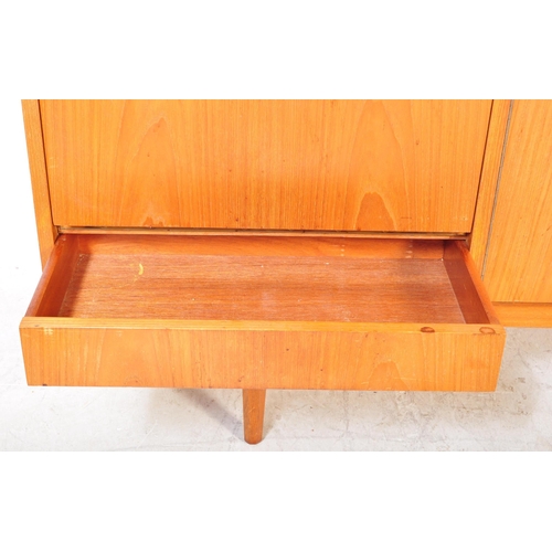 1177A - A vintage mid 20th Century teak wood side board. The sideboard having a central pair of sliding door... 