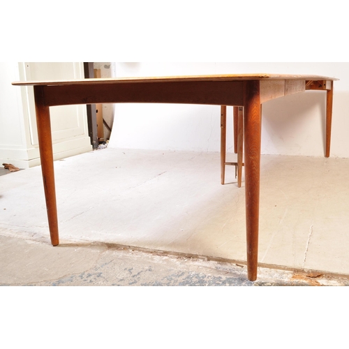 1185A - A mid century Danish large teak triple leaf extending dining table. Raised on tapering legs  with ex... 