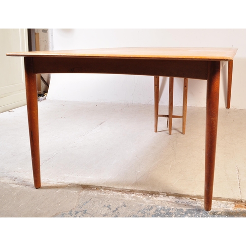 1185A - A mid century Danish large teak triple leaf extending dining table. Raised on tapering legs  with ex... 