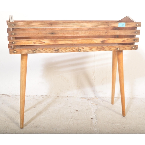 1187 - A retro vintage 20th Century teak wood plant stand / planter having a slatted teak wood body with ch... 