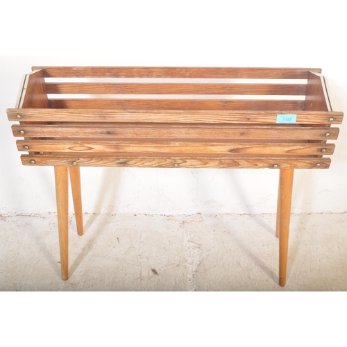 1187 - A retro vintage 20th Century teak wood plant stand / planter having a slatted teak wood body with ch... 