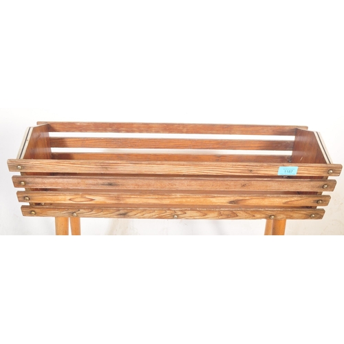 1187 - A retro vintage 20th Century teak wood plant stand / planter having a slatted teak wood body with ch... 