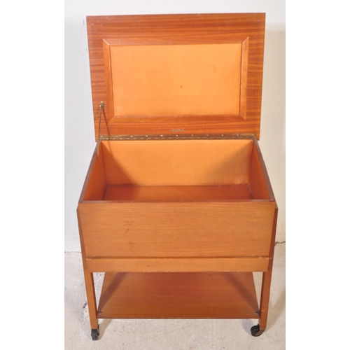 1192 - British Modern Design - A mid century teak wood sewing box being raised on squared legs with fielded... 