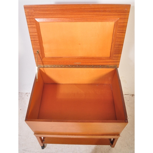 1192 - British Modern Design - A mid century teak wood sewing box being raised on squared legs with fielded... 