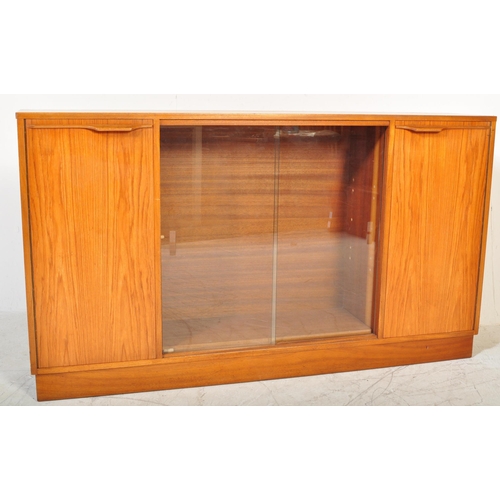 1196 - A retro 20th Century Scandinavian teak bookcase / display cabinet having two central sliding glass d... 