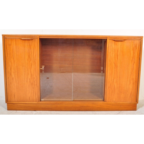 1196 - A retro 20th Century Scandinavian teak bookcase / display cabinet having two central sliding glass d... 