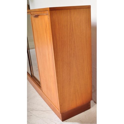 1196 - A retro 20th Century Scandinavian teak bookcase / display cabinet having two central sliding glass d... 