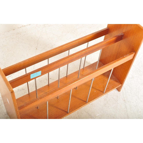 1217A - A vintage mid 20th Century1970's  teak wood magazine rack. The rack having three sections with wire ... 