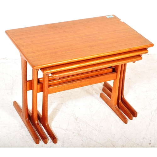 1227A - A vintage mid 20th Century teak wood nest of tables. The tables of rectangular form raised on rounde... 