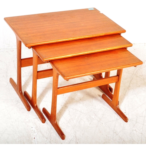 1227A - A vintage mid 20th Century teak wood nest of tables. The tables of rectangular form raised on rounde... 