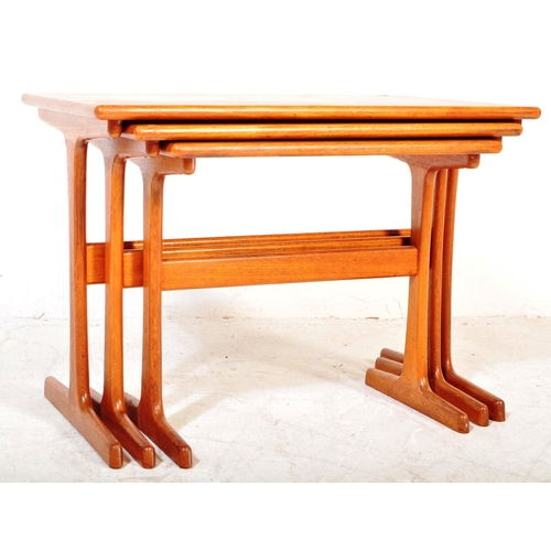 1227A - A vintage mid 20th Century teak wood nest of tables. The tables of rectangular form raised on rounde... 