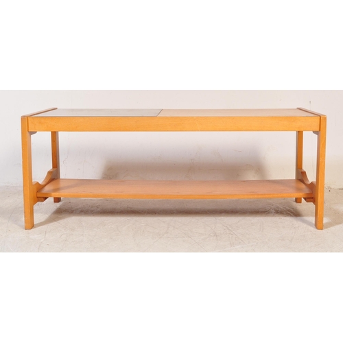 1230a - A retro vintage mid 20th Century teak wood coffee table. Of rectangular shape with a drop in glass s... 