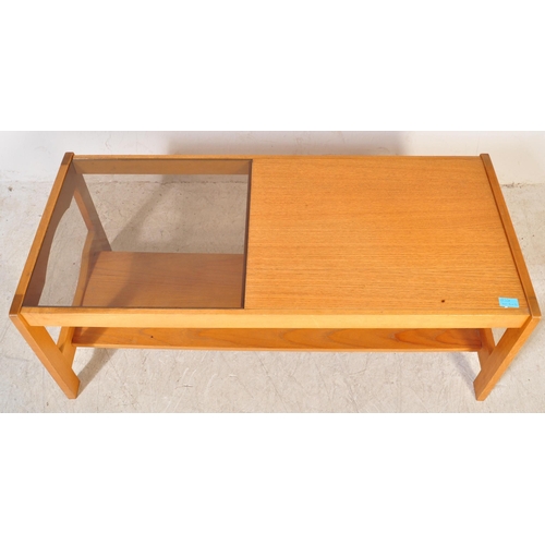 1230a - A retro vintage mid 20th Century teak wood coffee table. Of rectangular shape with a drop in glass s... 