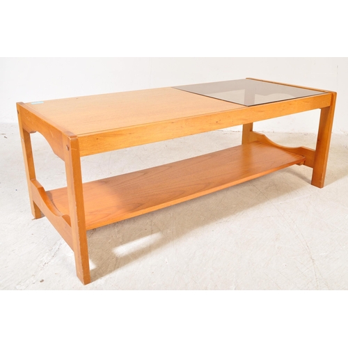 1230a - A retro vintage mid 20th Century teak wood coffee table. Of rectangular shape with a drop in glass s... 