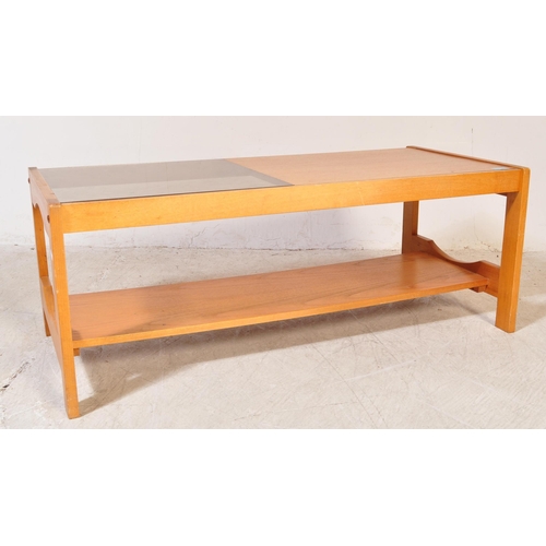 1230a - A retro vintage mid 20th Century teak wood coffee table. Of rectangular shape with a drop in glass s... 