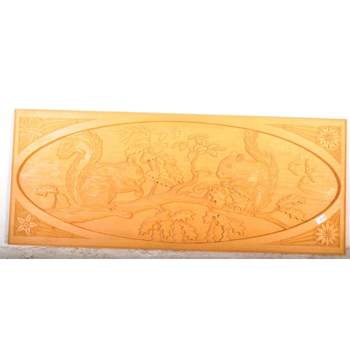 1237a - A contemporary pine wood carved wall hanging mounted plaque. Depicting squirrels sat on a branch for... 