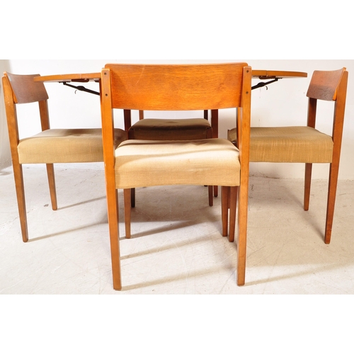 1240a - A retro vintage mid 20th Century teak drop leaf table with four chairs. The table of circular form w... 