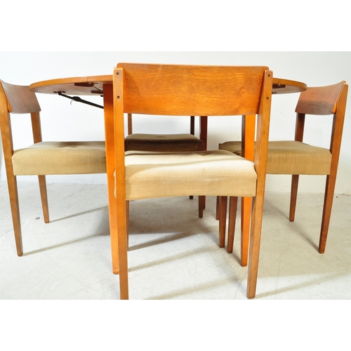 1240a - A retro vintage mid 20th Century teak drop leaf table with four chairs. The table of circular form w... 