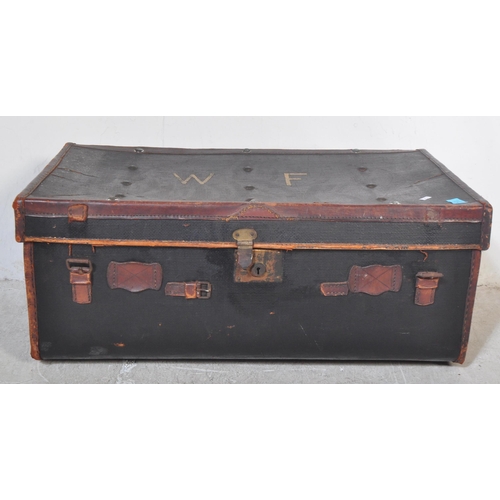 1256 - An early 20th century black leather steamer type travel trunk with white stencilled initials to lid ... 